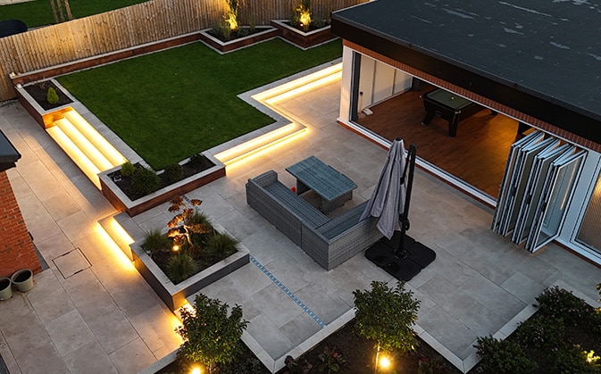 Terrace and lawn lit at dusk, Warrington