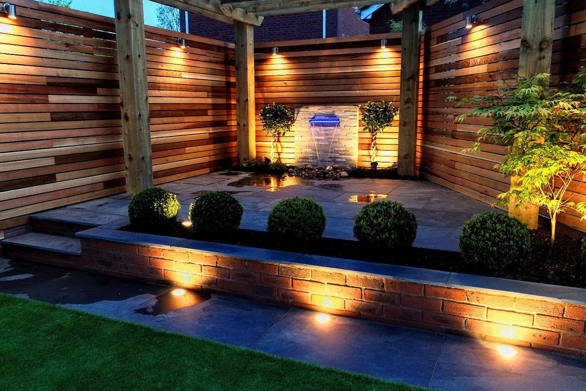 Cedar screens and water feature lit at dusk
