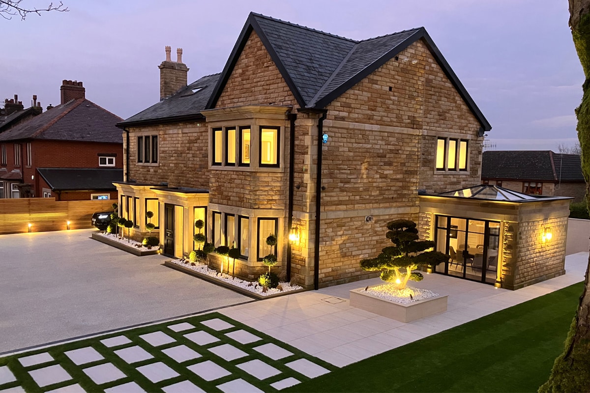 A Cheshire home and garden lit at dusk